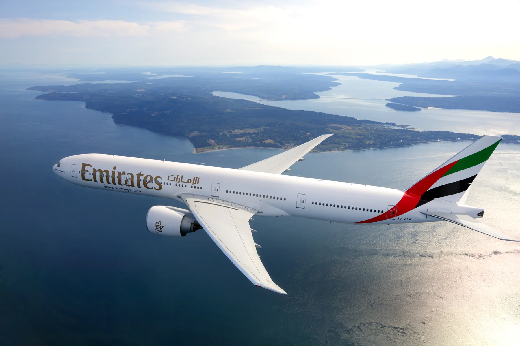 Emirates aircraft flying over the coast